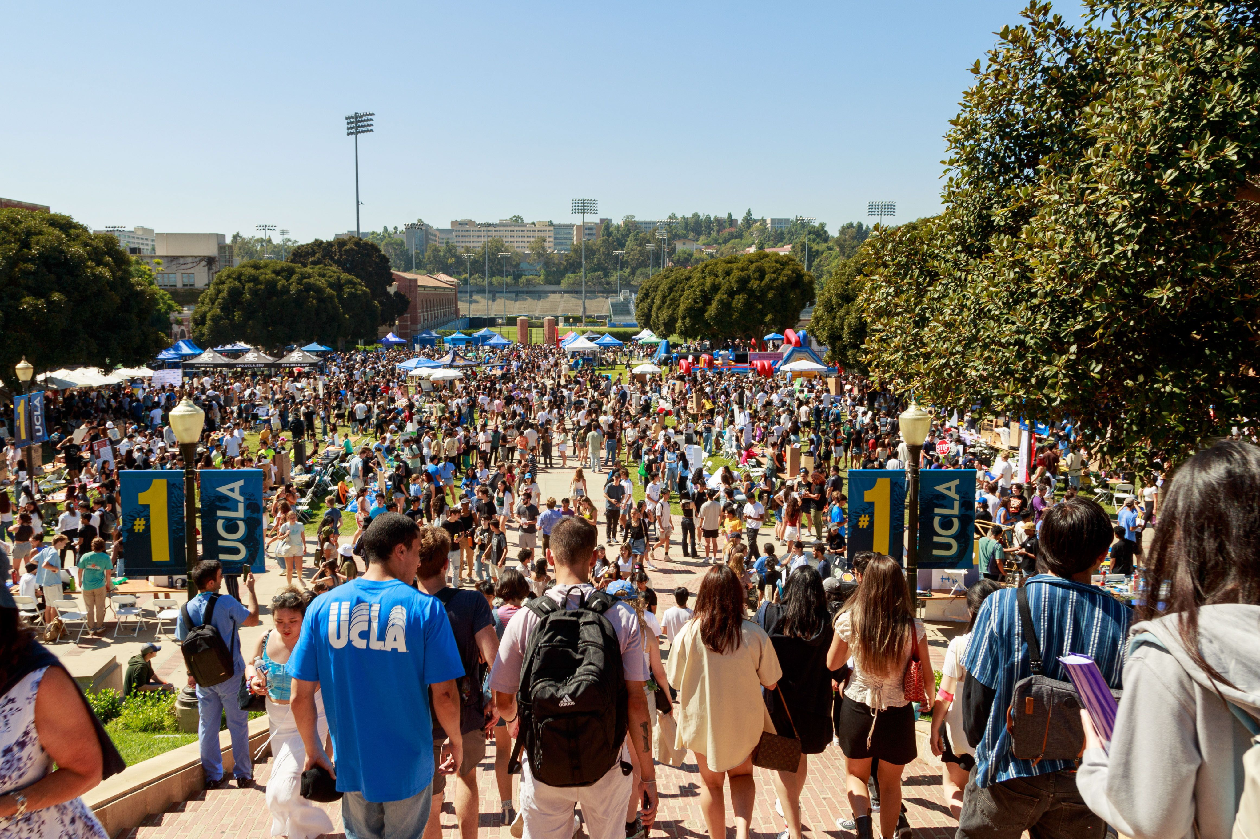 A diverse group of students gather for a large event on campus